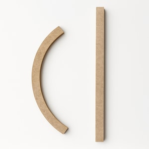 Two unfinished, light brown wooden pieces against a white background. One piece is a long, straight rectangle. The other is a curved, semi-circular shape. Both pieces have a smooth, matte finish.