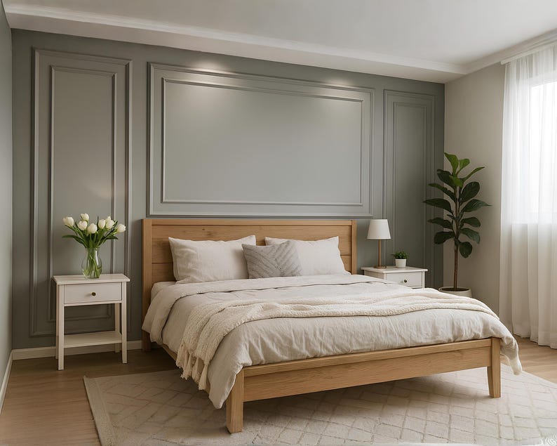 May include: A light wood bed frame with a headboard, dressed with neutral-colored bedding. Two matching nightstands flank the bed, one with a vase of white flowers. A potted plant and a window with sheer curtains are also visible.