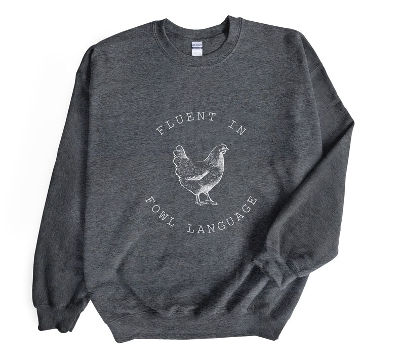 May include: Gray sweatshirt with a white graphic of a chicken and the text "Fluent in Fowl Language".