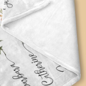 May include: White fleece blanket with a floral design and the text "Once upon a time... Catherine" printed in black.
