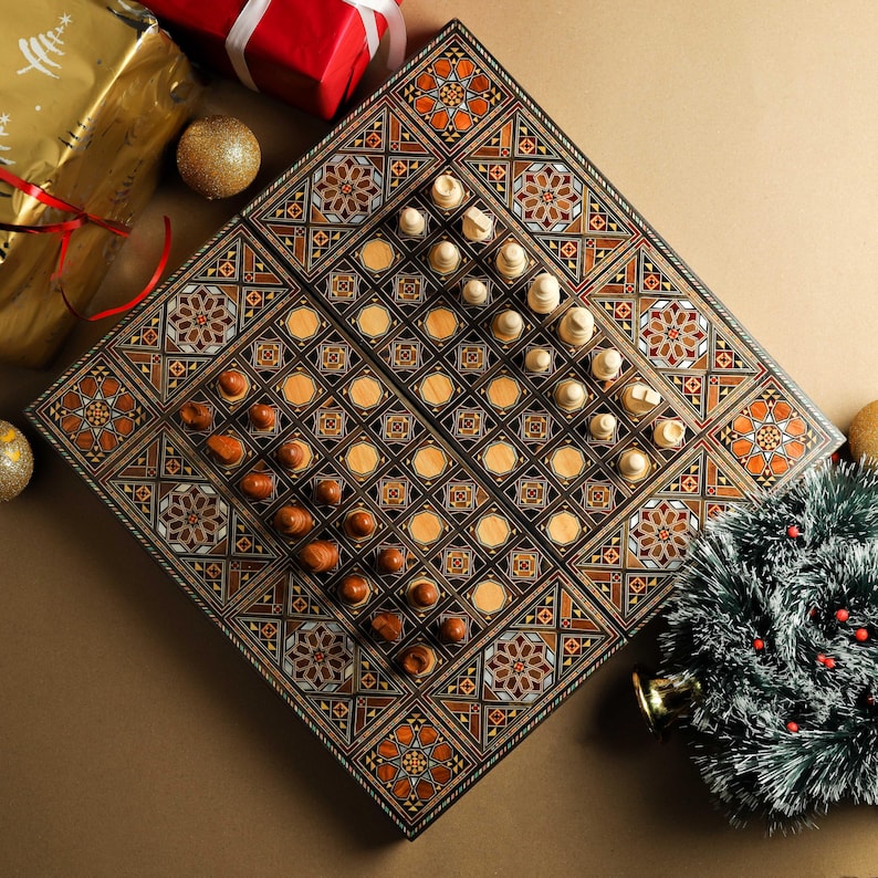 May include: A wooden game board with intricate inlaid designs in shades of brown, black, and white. The board is divided into two sections, one for chess and one for draughts. The chess pieces are arranged on the board, and the draughts pieces are in their starting positions.