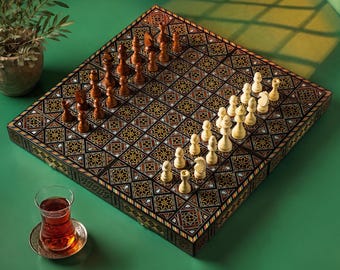 May include: A square wooden chessboard featuring intricate geometric mother-of-pearl inlay patterns across the surface. The board is set with a complete collection of dark brown wooden chess pieces on one side and light cream wooden pieces on the other.