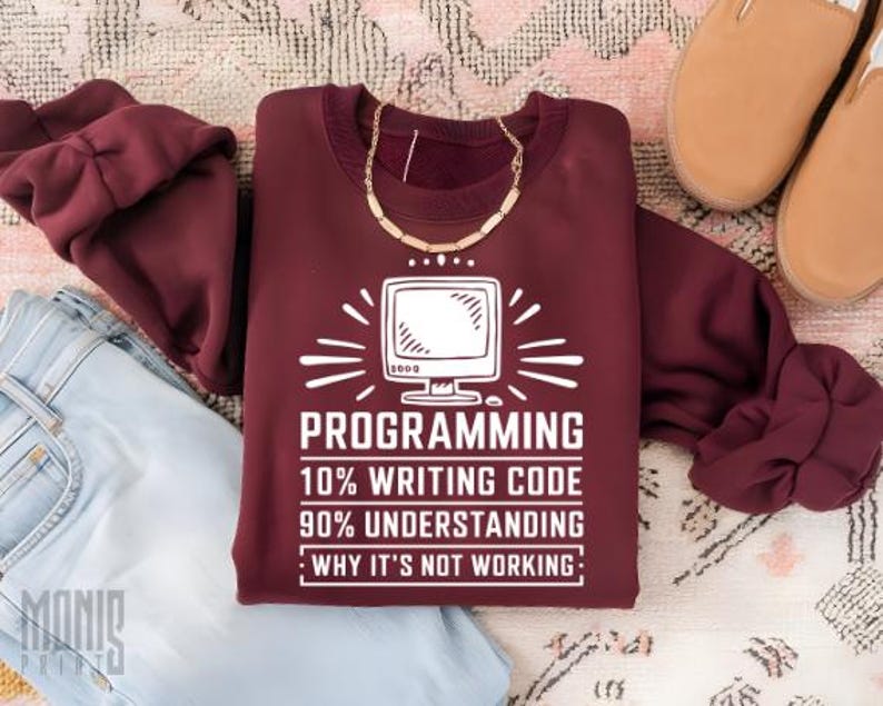 May include: A maroon sweatshirt with a white graphic print that reads "PROGRAMMING 10% WRITING CODE 90% UNDERSTANDING : WHY IT'S NOT WORKING:" and a stylized image of a computer monitor.