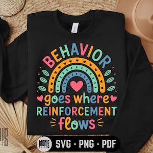 Puede incluir: Sudadera negra con un diseño de arcoíris y el texto "El comportamiento va donde fluye el refuerzo".