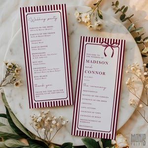 May include: Two wedding ceremony programs with burgundy and white striped borders. The programs feature text including the wedding party details and ceremony schedule. The programs are on a marble surface with floral accents.