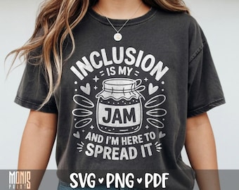 May include: A charcoal grey short-sleeve t-shirt featuring a white graphic of a jar of jam. The text reads INCLUSION IS MY JAM AND I'M HERE TO SPREAD IT, surrounded by small heart and leaf-like shapes. The design has a distressed, textured appearance.