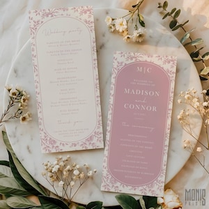 May include: Two wedding ceremony programs with floral designs. One program lists the wedding party, and the other welcomes guests to the wedding of Madison and Connor. The programs are light pink with floral borders.