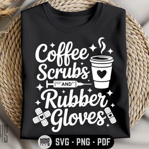 May include: Black t-shirt with the words "Coffee Scrubs and Rubber Gloves" in white script. The design includes a coffee cup with a heart, a syringe, and bandages. The shirt is displayed on a woven surface.