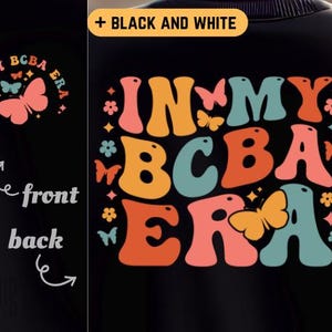 May include: Black sweatshirt with a colourful retro design that says "In My BCBA Era". The design features a butterfly and flowers.