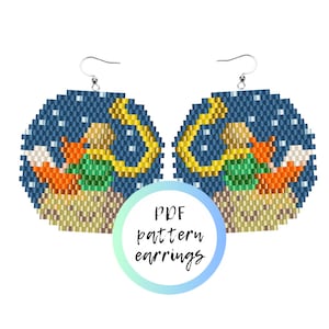May include: A pair of beaded earrings with a fox, moon, and stars design. The earrings are round and have a blue background with white stars. The fox is orange and white and is sitting on a crescent moon. The moon is yellow and has a gold outline. The earrings are made with seed beads and are a PDF pattern.