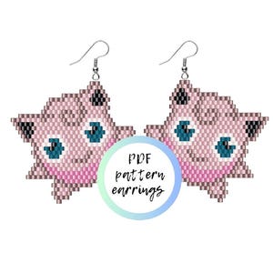 May include: A pair of beaded earrings shaped like a pink cartoon character with large blue eyes, black ear tips, and a small smile. The earrings feature silver-toned metal hooks. A circular graphic in the center displays the text PDF pattern earrings.