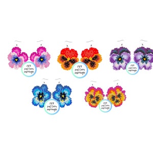 Op de afbeelding: Zes paar kralen oorbellen in de vorm van viooltjes. De oorbellen zijn in verschillende kleuren, waaronder paars, blauw, roze, oranje en geel. Elk paar oorbellen heeft een klein label met de tekst "DIY pattern earrings".