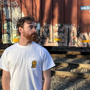 Learn A halo- Unisex Heavy Cotton Pocket Tee.