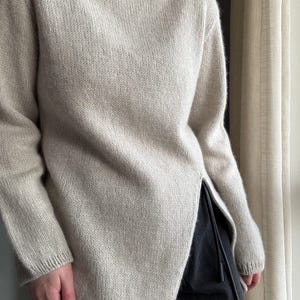 Liv Sweater Knitting Pattern: A modern, refined design for a turtleneck pullover with minimalistic top-down construction for women.