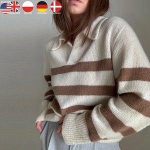 Puede incluir: Un suéter de rayas blancas y marrones con cuello. El suéter está hecho de una tela suave y tejida.