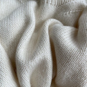 Create a warm Ness Sweater with a standing long neck using MorecaKnit's knitting pattern