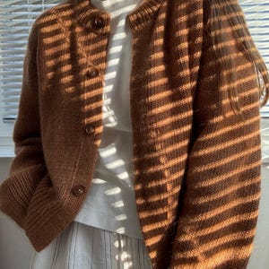 Modern cardigan tutorial featuring top down yoke shaping and relaxed silhouette.