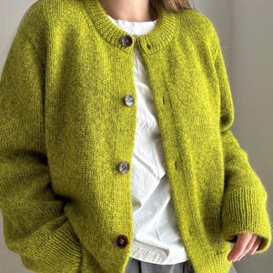 Stockinette stitch cardigan with drop shoulders and crewneck, designed for ladies and girls.