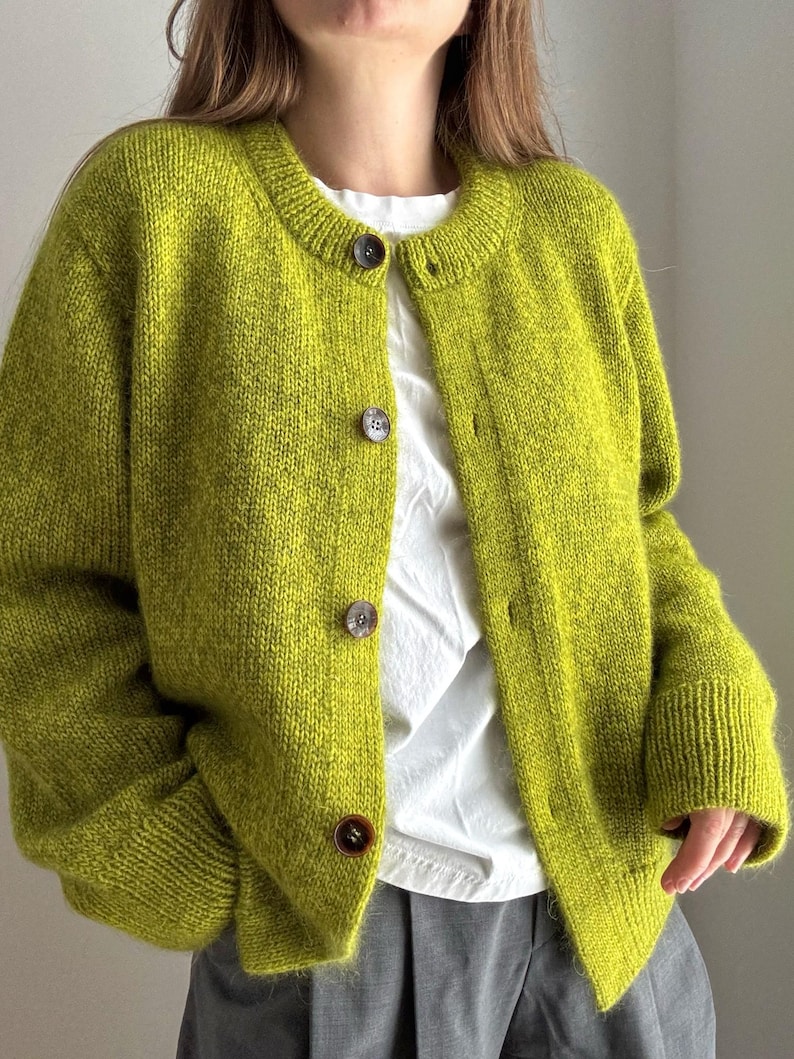 Stockinette stitch cardigan with drop shoulders and crewneck, designed for ladies and girls.