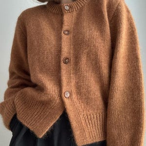 Janette Cardigan with folded edge finish and neat double knitting front bands.