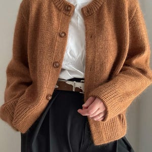Knit guide and knit scheme for an oversized, slightly cropped button up cardigan construction.