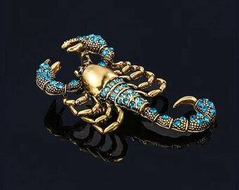 Broche Escorpión Dorado con Gemas azules