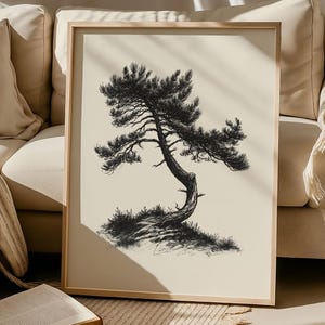 May include: A framed black and white illustration of a bonsai tree. The tree has a curved trunk and detailed branches, set against a cream-colored background. The frame is a light wood color, and the artwork is displayed near a beige sofa.