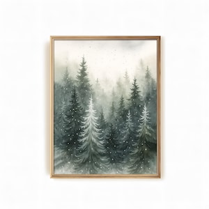 May include: A framed watercolor painting of a forest scene. The artwork depicts tall evergreen trees in shades of green and gray, with a misty background and falling snow. The frame is gold.