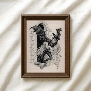 May include: A framed black and white illustration depicting a gothic scene. A winged figure embraces a person in a window. The artwork is in a dark brown frame. The text "YUNORA PRINTS" is at the bottom.