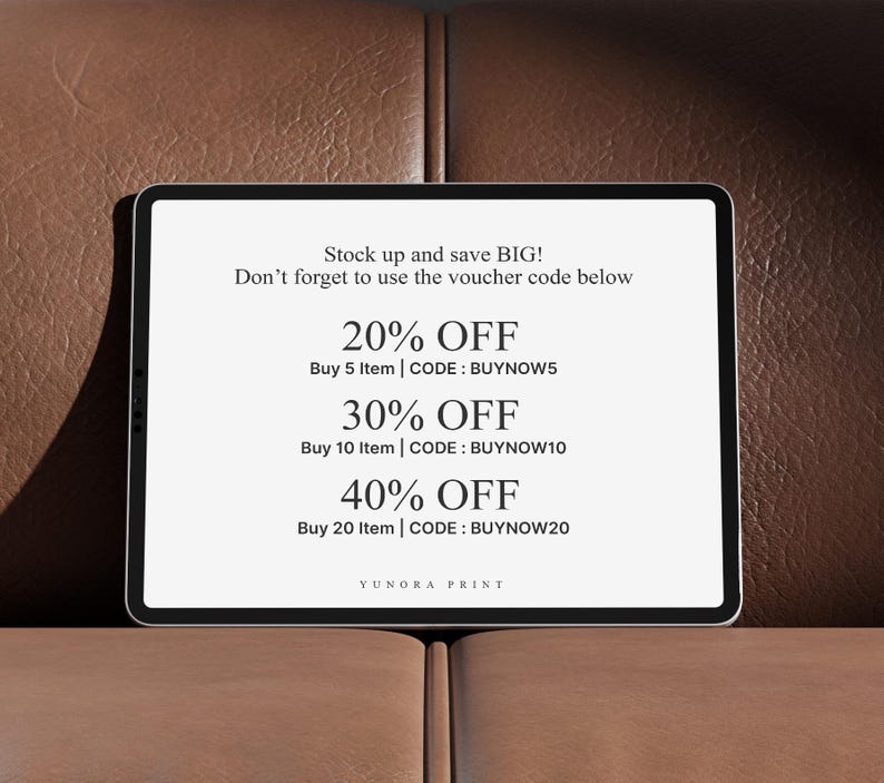 May include: A digital tablet displays text offering discounts: 20% off for buying 5 items, 30% off for 10 items, and 40% off for 20 items. The tablet is on a brown leather surface.