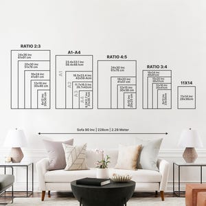 May include: A white wall displays a variety of rectangular art print sizes, including 24x36 inches, 20x30 inches, and 16x24 inches. The text on the wall indicates the aspect ratios and dimensions in inches and centimeters. A sofa and lamps are in the foreground.