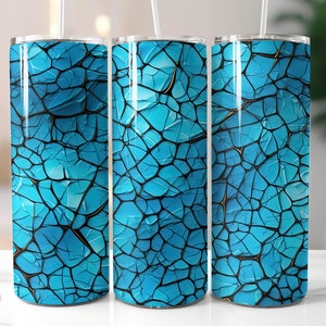 May include: Three stainless steel tumblers with a blue and black cracked paint design. The tumblers are all the same size and have a smooth, shiny finish.