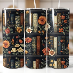 May include: Three stainless steel tumblers featuring a black background with a pattern of books and flowers. The flowers are in shades of orange, yellow, and white. The books are in shades of brown, blue, and green.