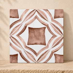 May include: A square ceramic tile featuring a white background with a symmetrical, hand-painted watercolour pattern in shades of terracotta brown. The design consists of a central solid square surrounded by four curved, leaf-like shapes.