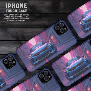 May include: iPhone tough cases with a blue car design. The cases have a dual-layer construction for durability and protection, supporting wireless charging. The design features a blue car in a city setting with pink and purple hues.