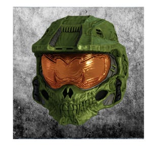 May include: A green and orange helmet with a skull-like design. The helmet has a textured surface and a reflective orange visor. The design includes details such as vents and a chin area.