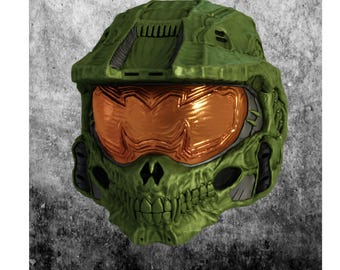 Op de afbeelding: Een groen en oranje helm met een schedelachtig ontwerp. De helm heeft een textuur en een reflecterend oranje vizier. Het ontwerp bevat details zoals ventilatieopeningen en een kin.