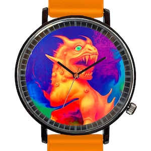 May include: A round wristwatch with a black case and an orange band. The watch face features a colorful illustration of a dragon with green eyes. The watch hands are black.