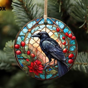 May include: A round Christmas ornament with a stained glass design featuring a black crow perched on a branch with red berries. The ornament has a blue, green, and gold color scheme.