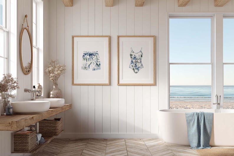 Add a touch of coastal elegance to your home with this coordinated set of two floral swimwear watercolor prints. Featuring a matching one-piece swimsuit and swim trunks adorned with soft blue florals and botanical accents, this collection blends vintage beach charm with sophisticated coastal style. Perfect for bathrooms, beach houses, lake cottages, dressing rooms, pool houses, and summer-inspired interiors.
