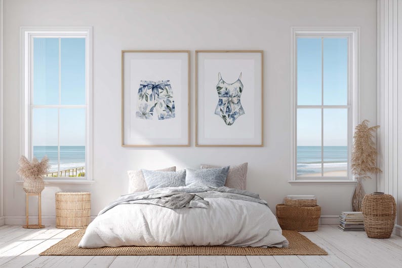 Add a touch of coastal elegance to your home with this coordinated set of two floral swimwear watercolor prints. Featuring a matching one-piece swimsuit and swim trunks adorned with soft blue florals and botanical accents, this collection blends vintage beach charm with sophisticated coastal style. Perfect for bathrooms, beach houses, lake cottages, dressing rooms, pool houses, and summer-inspired interiors.