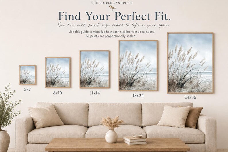 The image is a living room with a couch and a coffee table. There are four framed prints of the same size, ranging from 5x7" to 24x36", displayed on the wall. The prints are arranged in a row, with the largest one at the top and the smallest one at the bottom. The couch is positioned in front of the wall, and there is a vase of flowers on the coffee table.