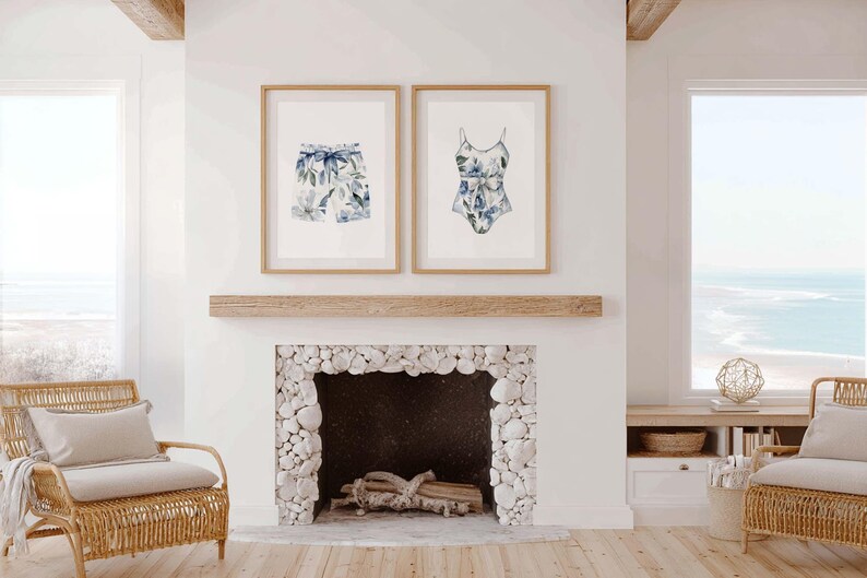 Add a touch of coastal elegance to your home with this coordinated set of two floral swimwear watercolor prints. Featuring a matching one-piece swimsuit and swim trunks adorned with soft blue florals and botanical accents, this collection blends vintage beach charm with sophisticated coastal style. Perfect for bathrooms, beach houses, lake cottages, dressing rooms, pool houses, and summer-inspired interiors.