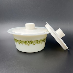 May include: White ceramic butter dish with a green floral pattern and a matching lid. The lid has a small knob on top.
