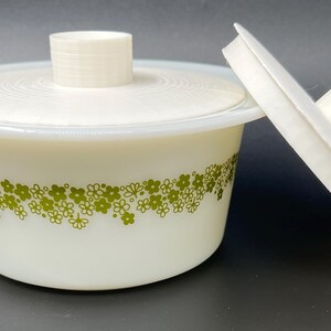May include: White ceramic bowl with a green floral pattern and a matching lid. The lid has a knob on top.