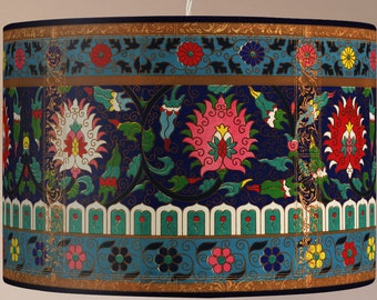 May include: A blue and gold lampshade with a floral pattern. The pattern features pink, white, red, and yellow flowers with green leaves. The lampshade has a gold trim around the top and bottom.