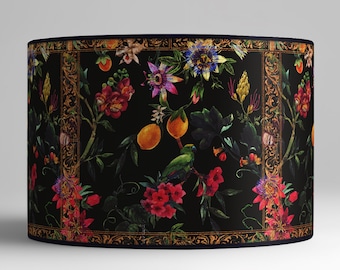 May include: Black lampshade with a floral pattern featuring parrots, lemons, and flowers in shades of red, pink, yellow, and green. The pattern is framed by a gold and black border.
