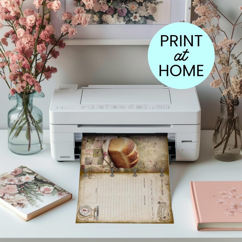 May include: A white printer is printing a vintage-style recipe sheet with a loaf of bread image. The sheet has a rustic design with a scale illustration and the text "Recipe". The image also includes pink flowers in vases and a notebook.