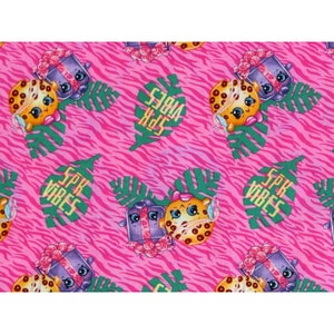 May include: Pink and green fabric with a repeating pattern of cartoon characters, a gift box, and the words "SPR VIBES".