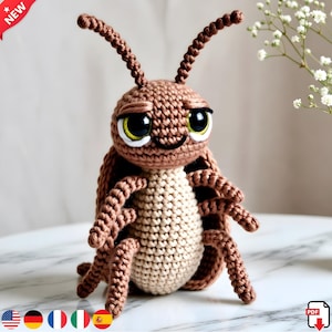 May include: A handmade crochet insect toy in shades of brown and beige. The toy has large, expressive eyes with yellow and white accents, and detailed legs and antennae. The word "NEW" is in a red banner in the upper left corner.